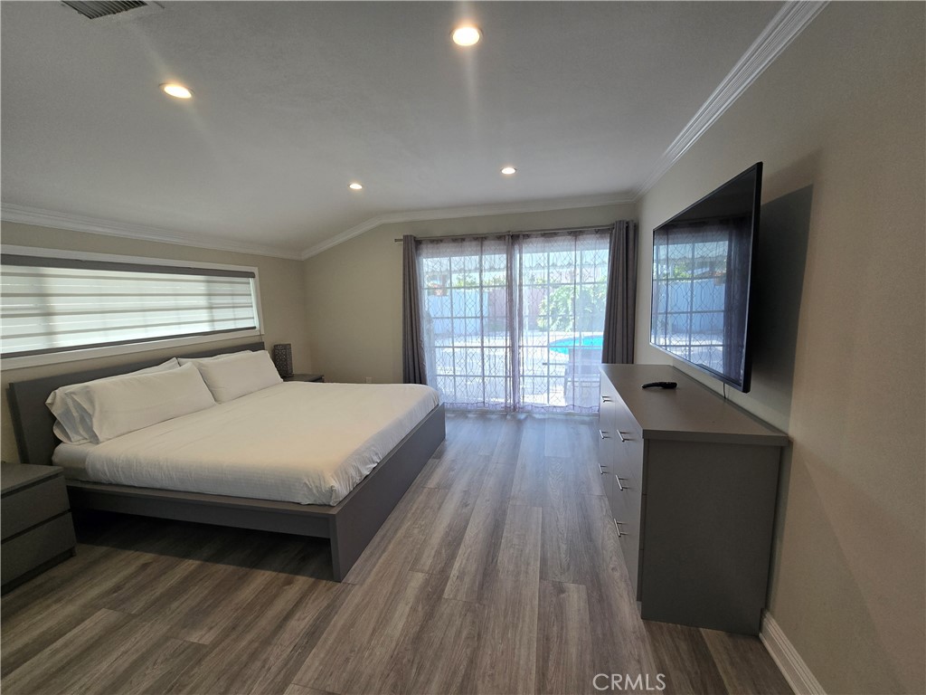 1925 South Kathy Lane Anaheim, CA 92802 - Photo 10 of 12 a bedroom with a large bed and wooden floor