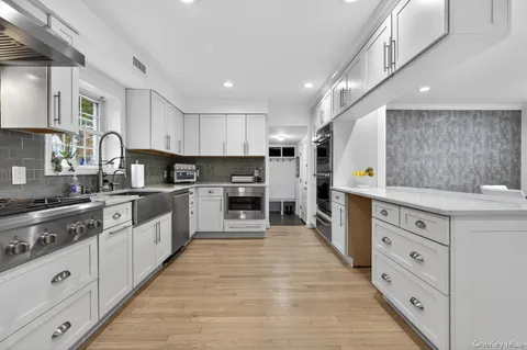 a large kitchen with stainless steel appliances lots of counter space sink and cabinets