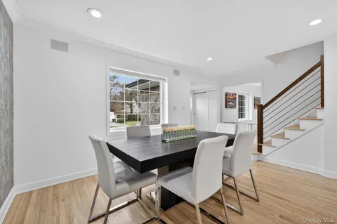 a view of a dining room with furniture window and wooden floor