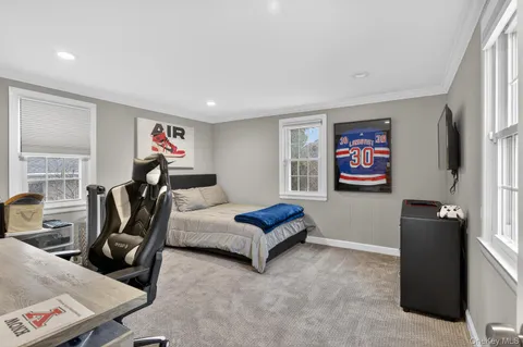 a bedroom with furniture and a flat screen tv