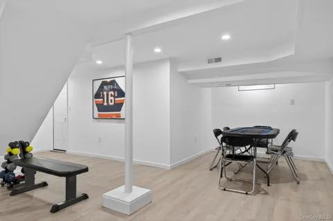 a view of a room with furniture and wooden floor