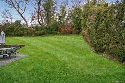 a view of a backyard with table and chairs and potted plants