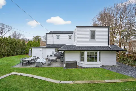 a view of a house with a backyard and a patio