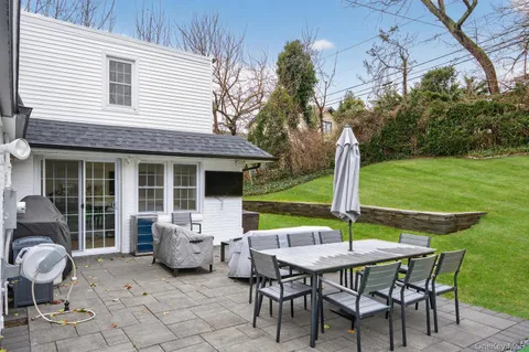 a view of a house with backyard sitting area and garden