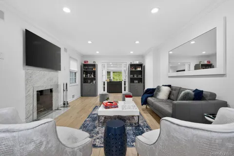a living room with furniture fireplace and flat screen tv