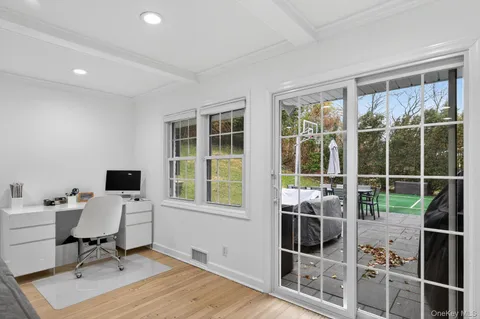 a view of a workspace with furniture and a window
