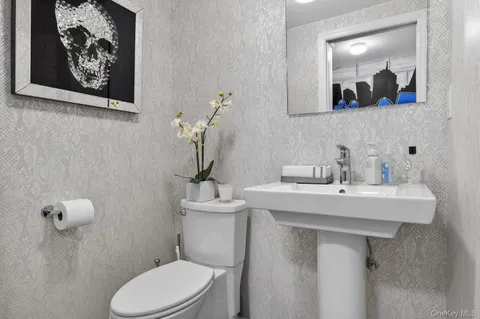 a bathroom with a toilet a sink and mirror