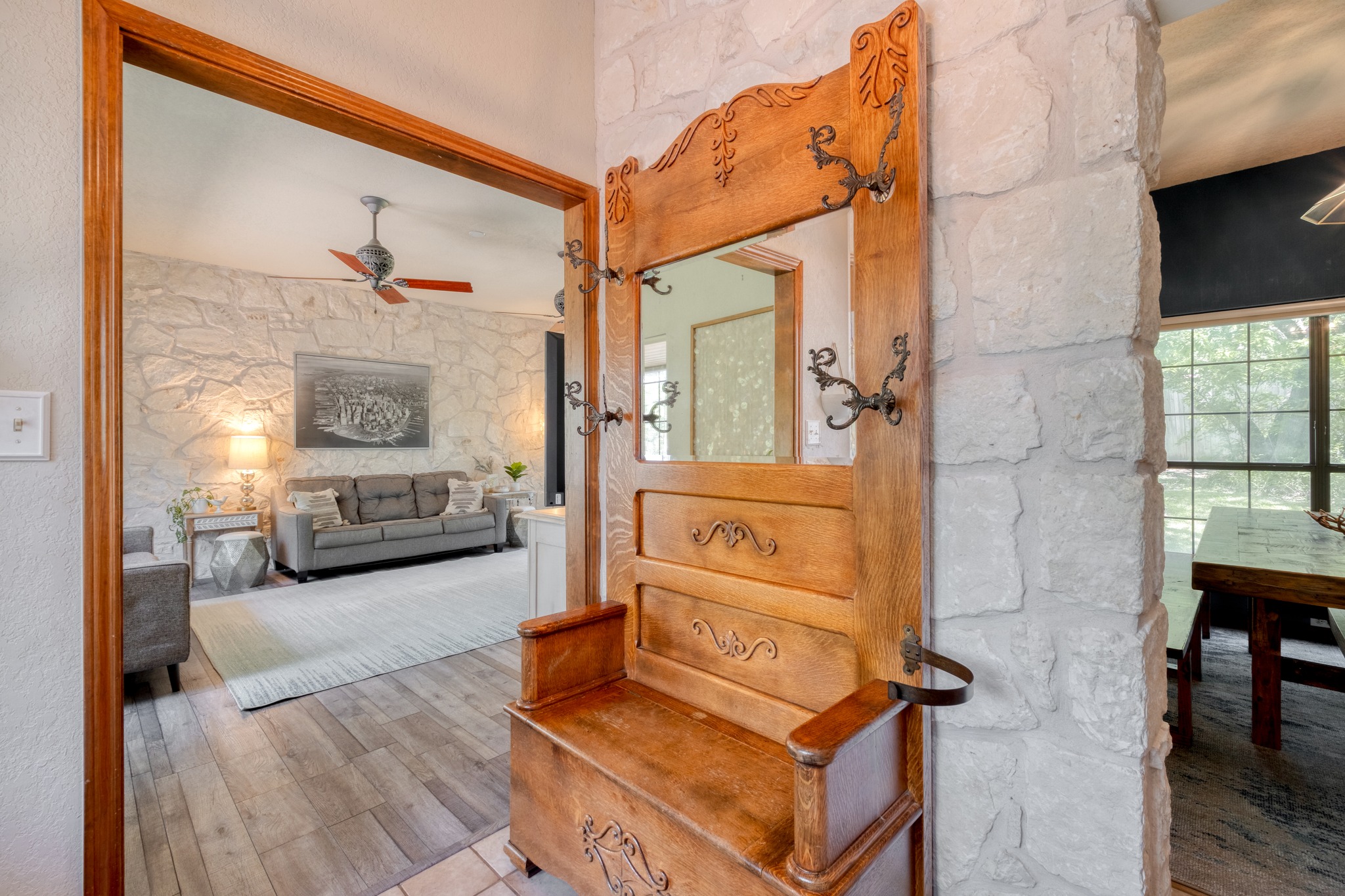 202 Ridgewood Drive Georgetown, TX 78628 - Photo 5 of 40 Stone wall accents featuring a wood-finish flooring and an open doorway