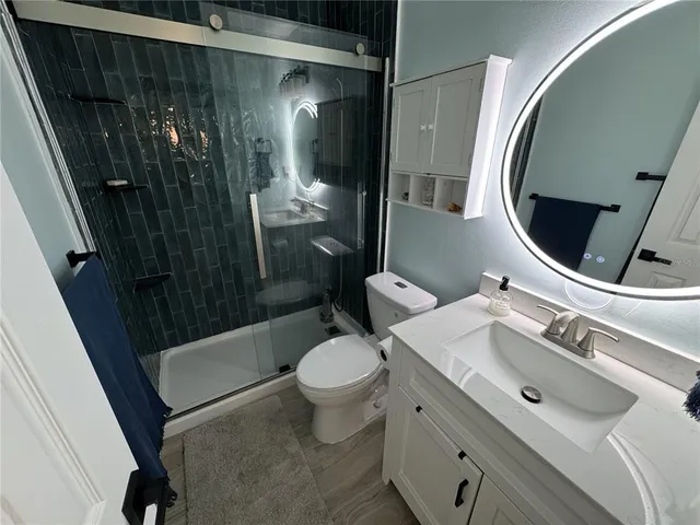 a bathroom with a sink toilet and shower