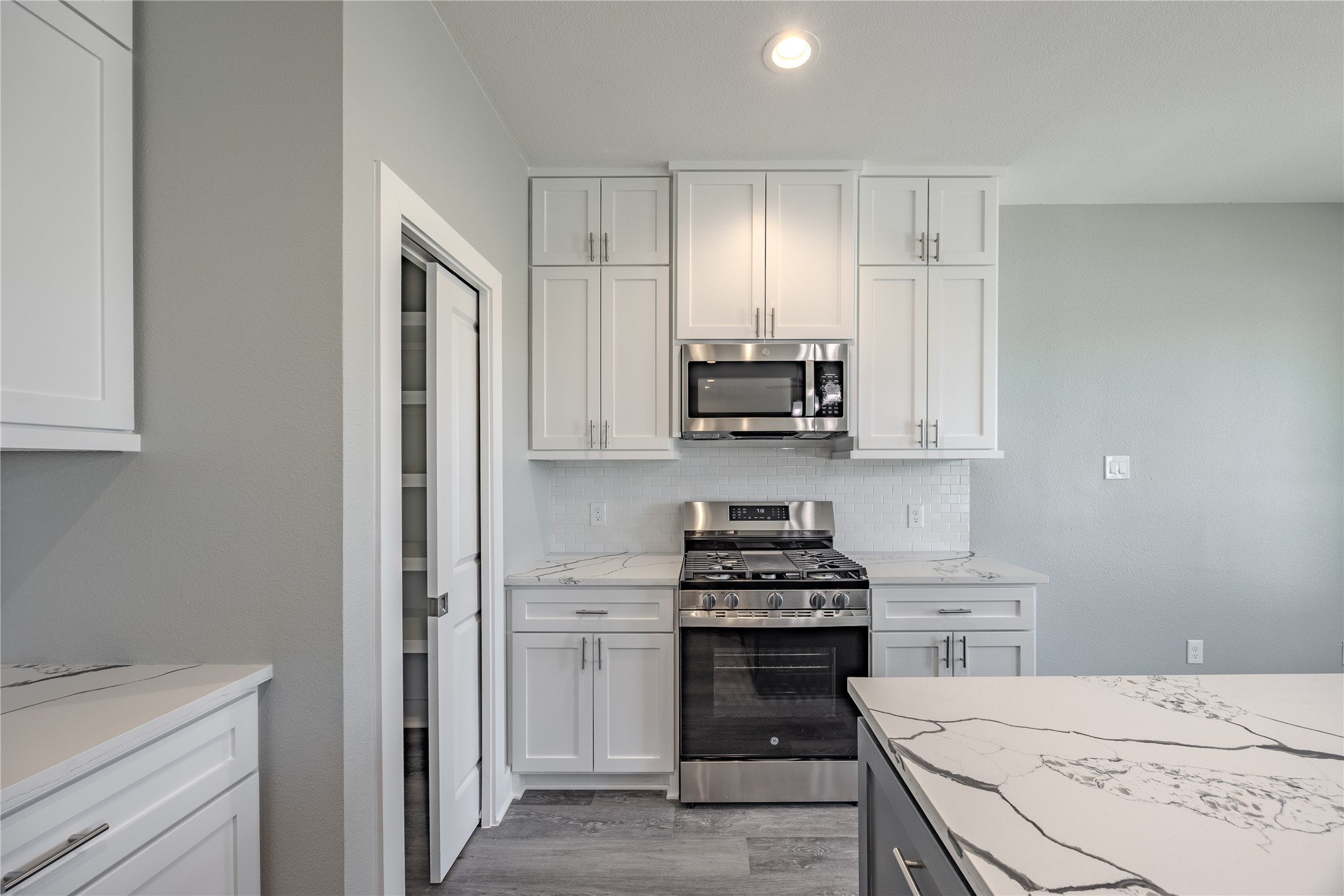 737 Ebenezer Lane Brenham, TX 77833 - Photo 11 of 25 a kitchen with stainless steel appliances a white stove top oven and a refrigerator