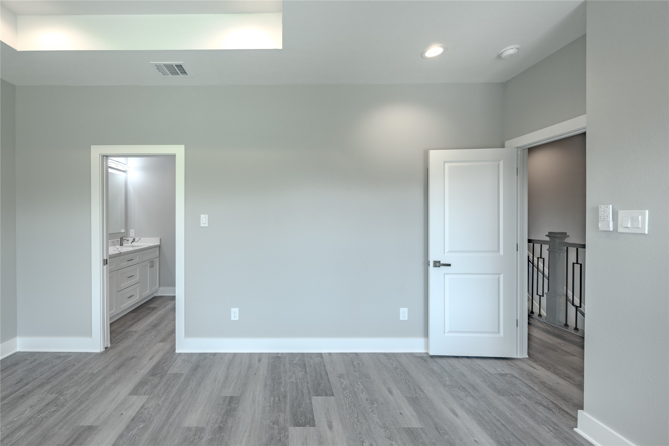 737 Ebenezer Lane Brenham, TX 77833 - Photo 4 of 25 a view of an empty room with wooden floor and a bathroom