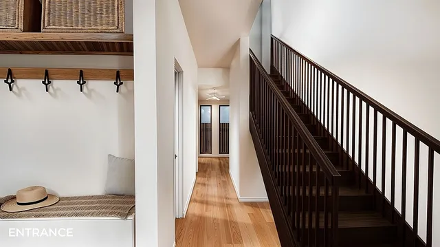 a view of a hallway with wooden floor and staircase
