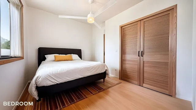 a bedroom with a bed and a window