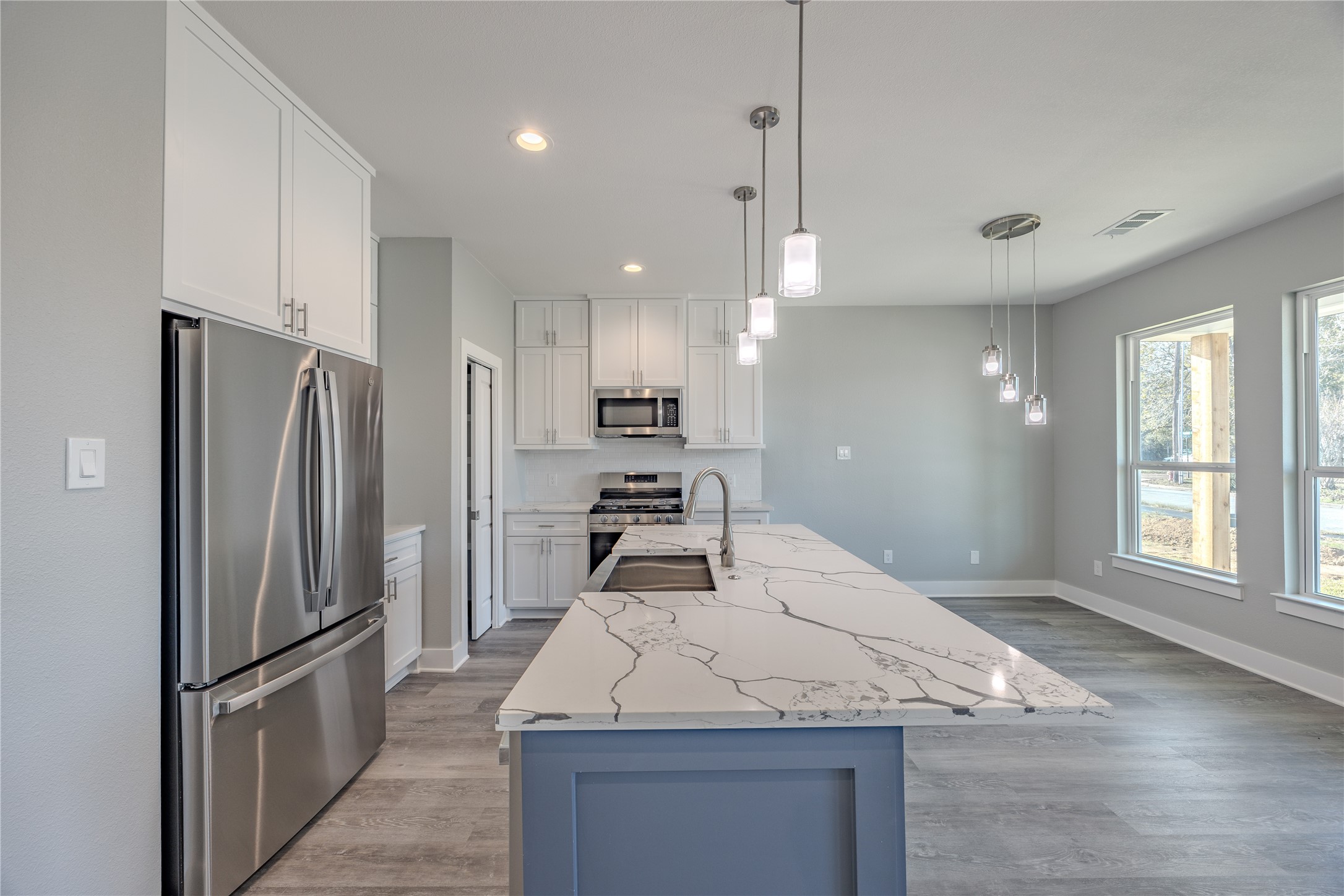 737 Ebenezer Lane Brenham, TX 77833 - Photo 10 of 25 a kitchen with kitchen island a counter top space stainless steel appliances and a window