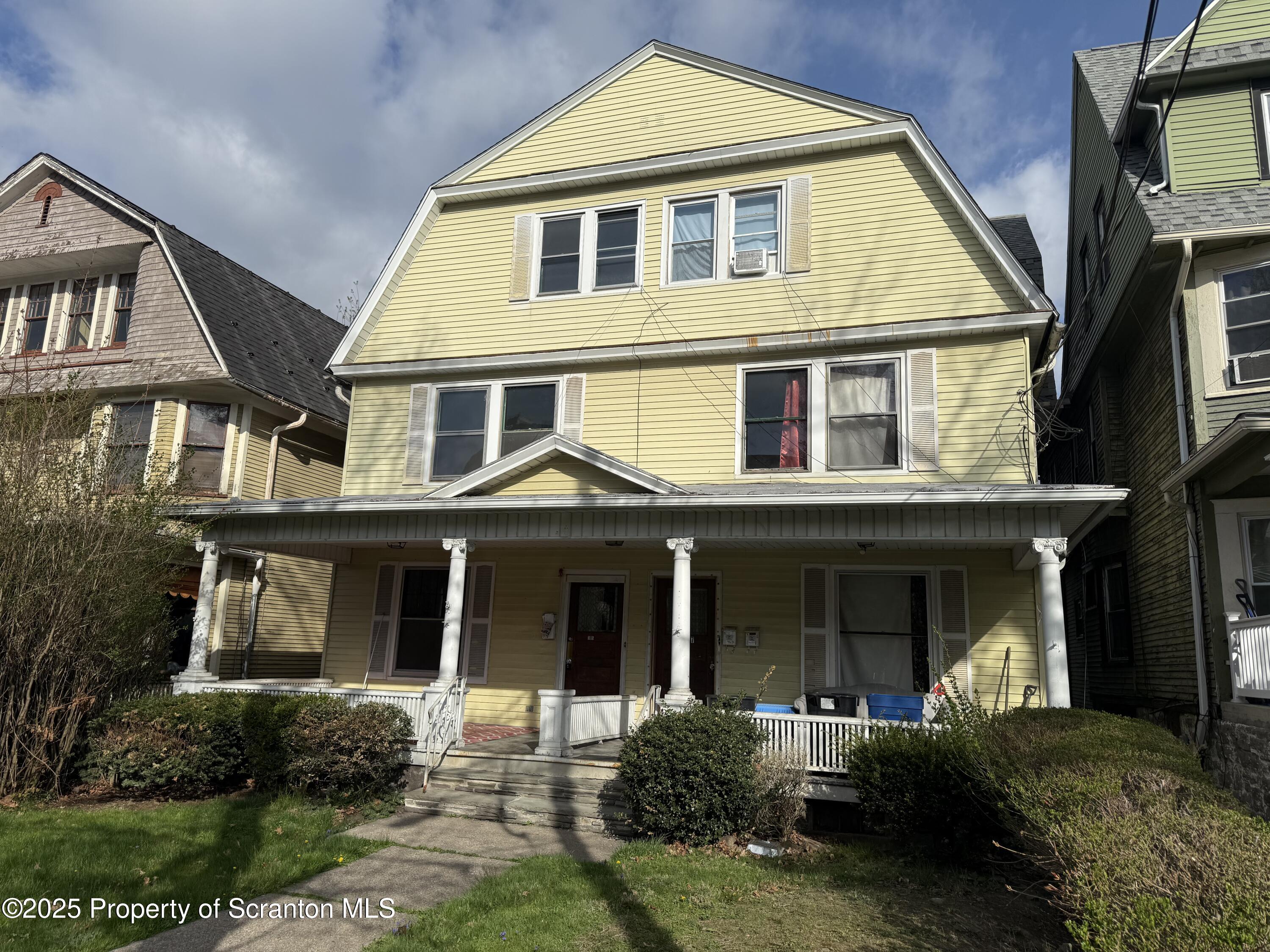 315 Wheeler Avenue Scranton, PA 18510 - Photo 1 of 18 a front view of a house with a yard