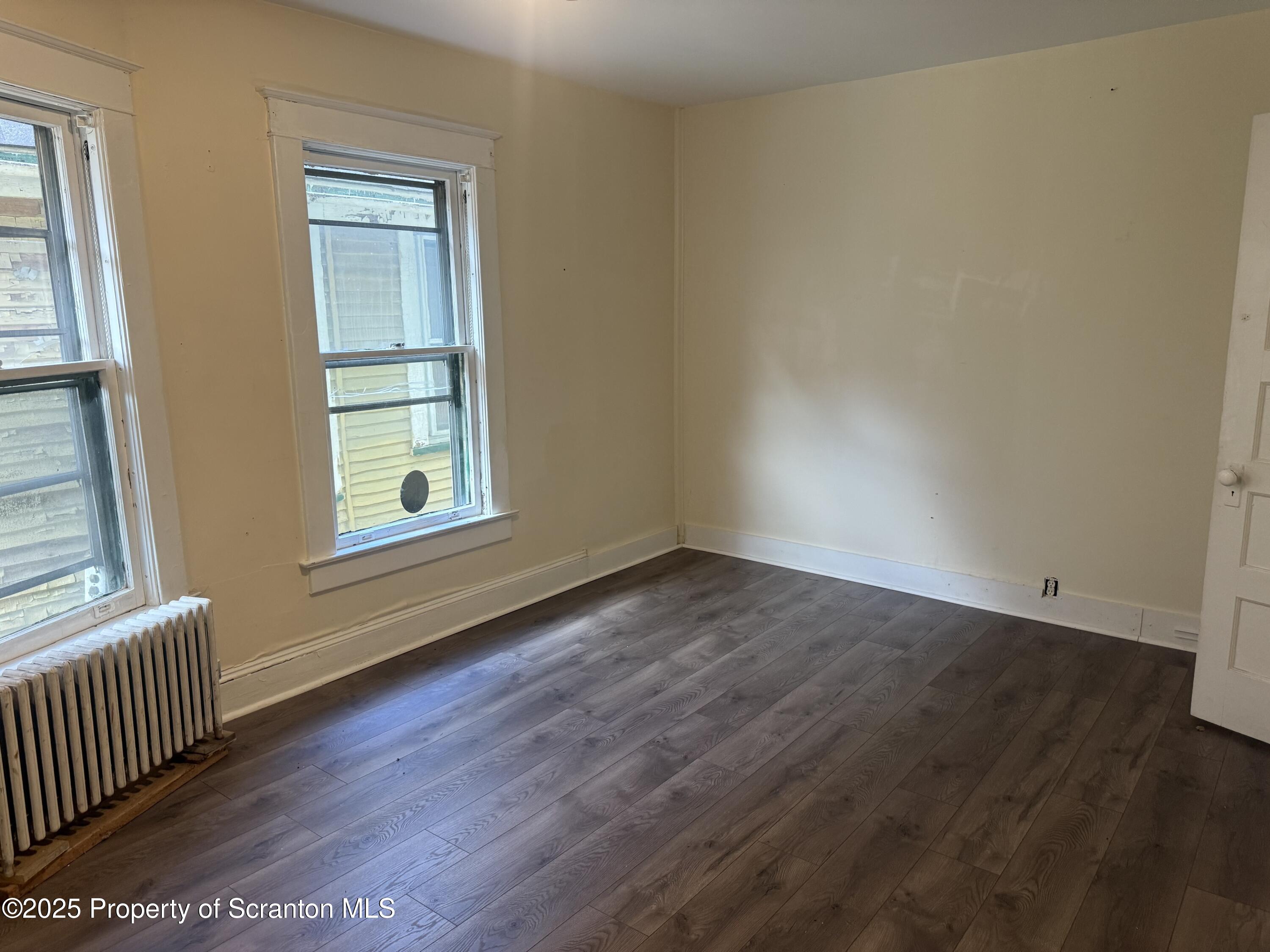 315 Wheeler Avenue Scranton, PA 18510 - Photo 17 of 18 an empty room with wooden floor and windows