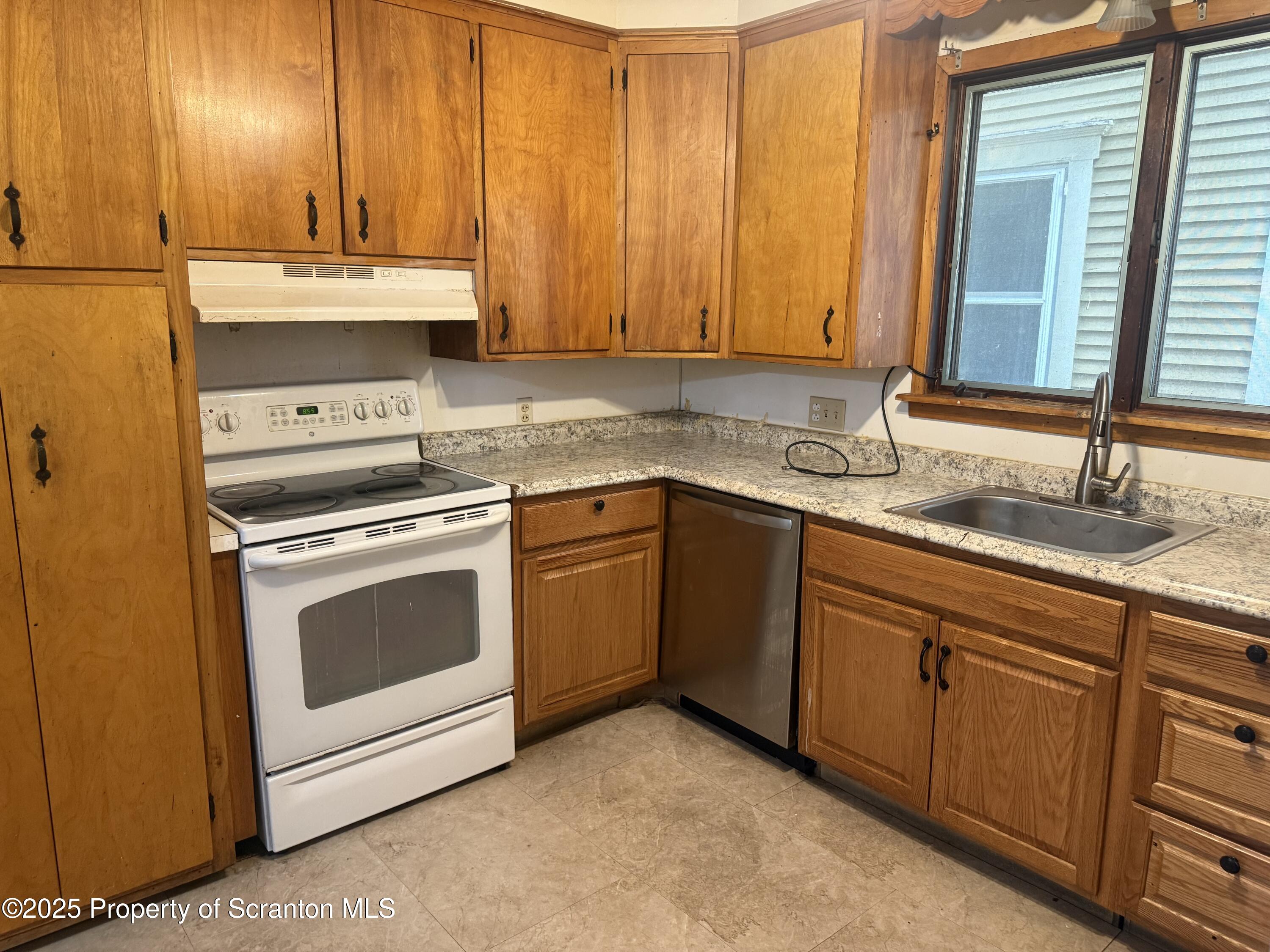 315 Wheeler Avenue Scranton, PA 18510 - Photo 7 of 18 a kitchen with a sink stove and cabinets