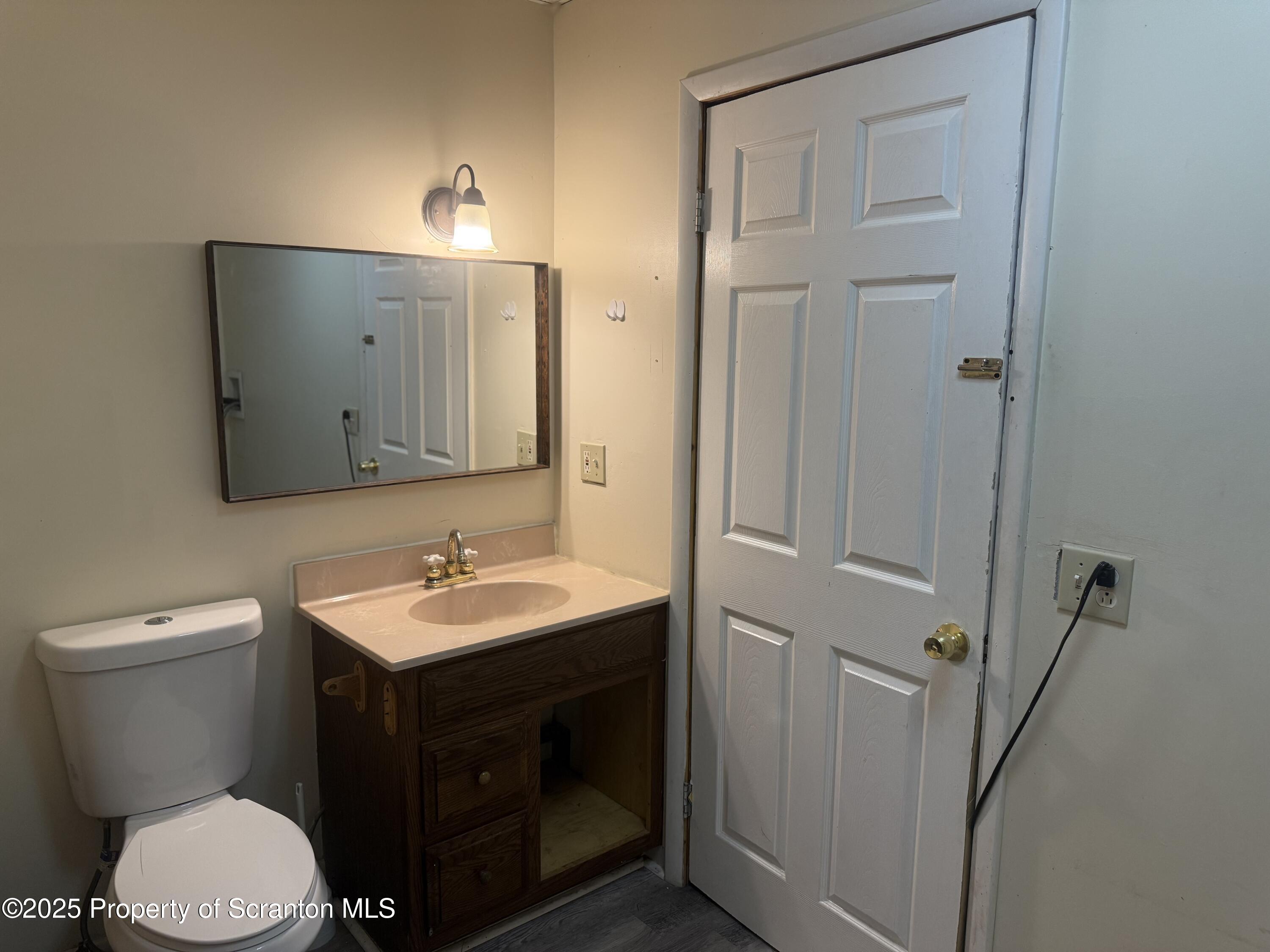 315 Wheeler Avenue Scranton, PA 18510 - Photo 9 of 18 a bathroom with a toilet sink and mirror