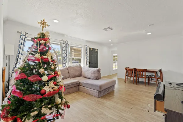 a living room with furniture and flowers