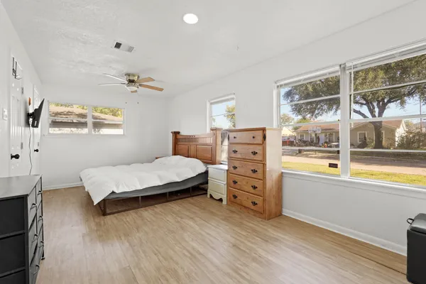 a bedroom with a bed and a window