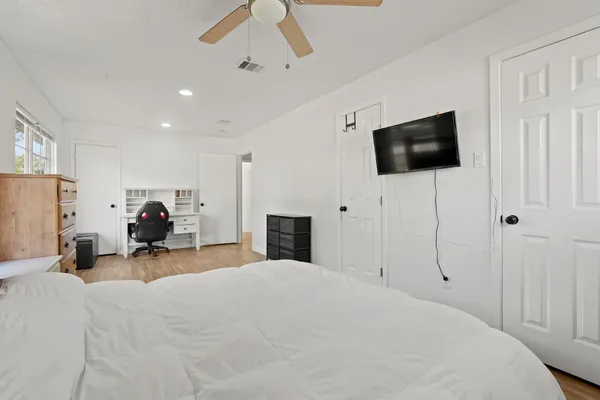 a bed room with a bed a television and a fireplace