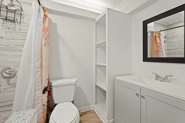a white toilet sitting next to a bathroom sink
