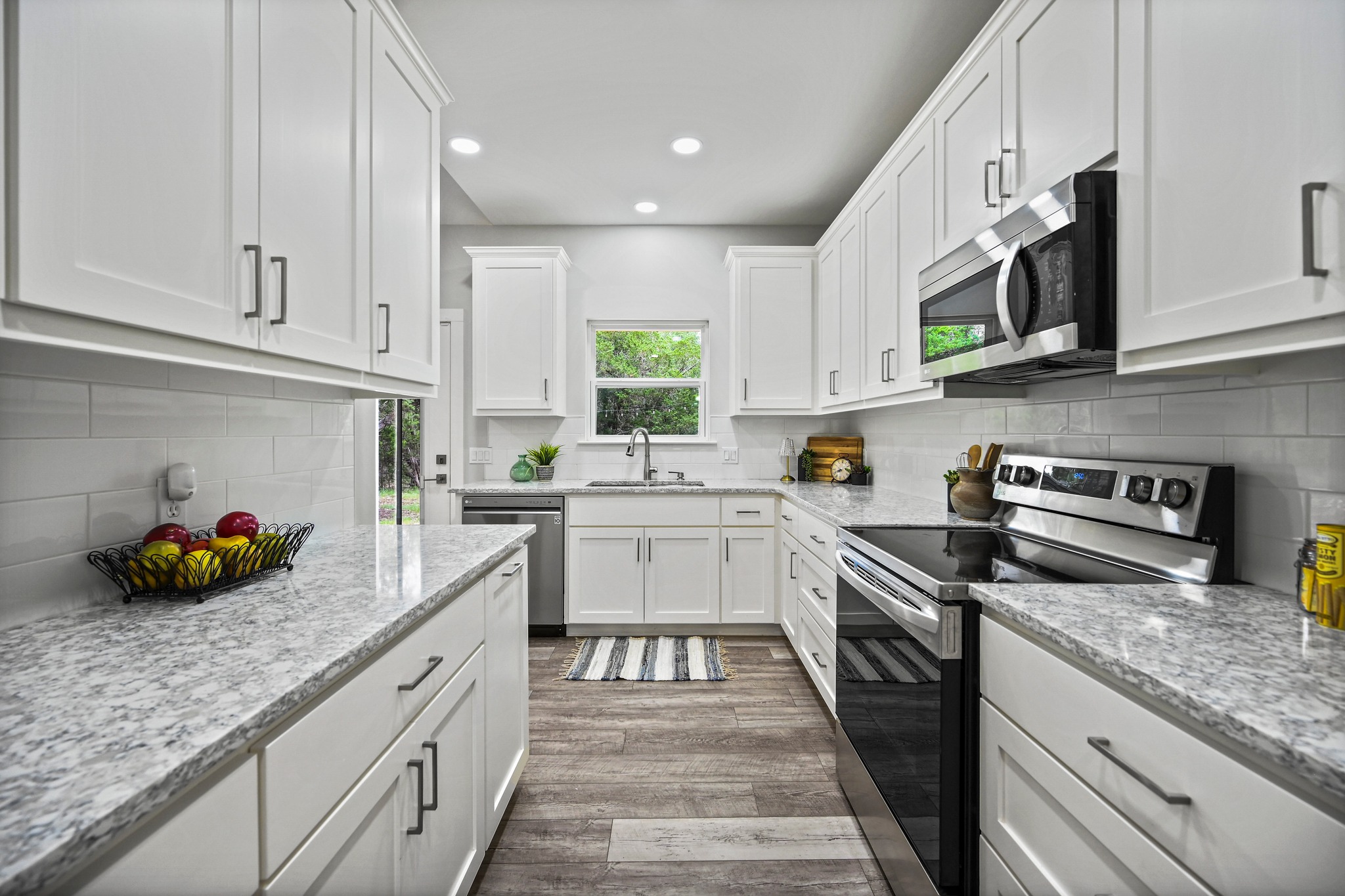 231 North Rainbow Ranch Road Wimberley, TX 78676 - Photo 15 of 40 Clean lines and ample counter space define this bright, functional culinary haven.
