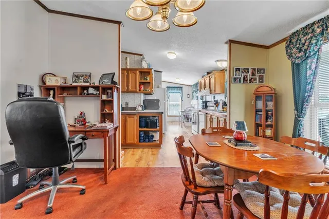 a dining room with furniture and a chandelier