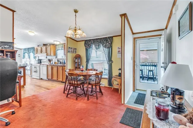 a dining room with furniture a chandelier and wooden floor