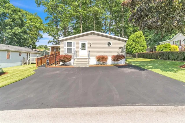 a view of house with outdoor space and parking