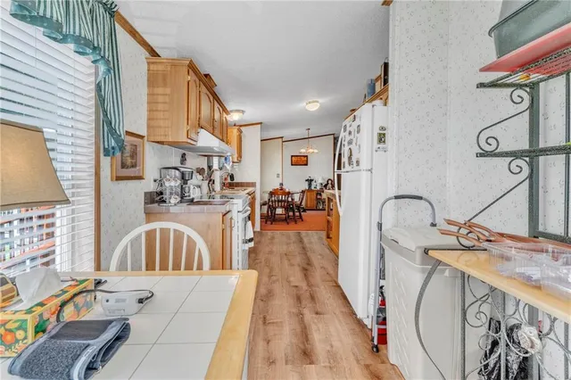 a view of a bathroom with sink mirror and furniture
