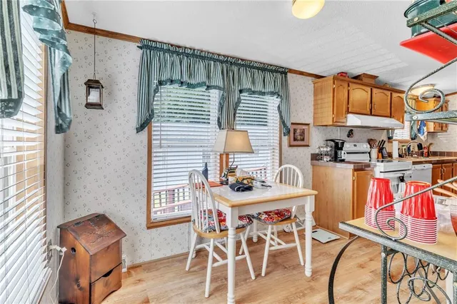a dining room with furniture a rug and a window