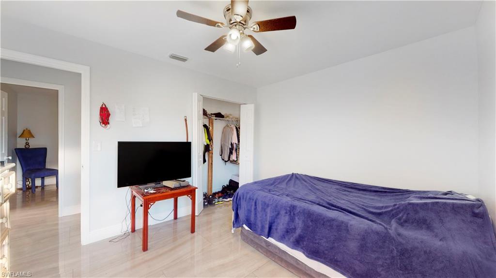 3903 35th Street Southwest Lehigh Acres, FL 33976 - Photo 12 of 16 a living room with furniture and a flat screen tv