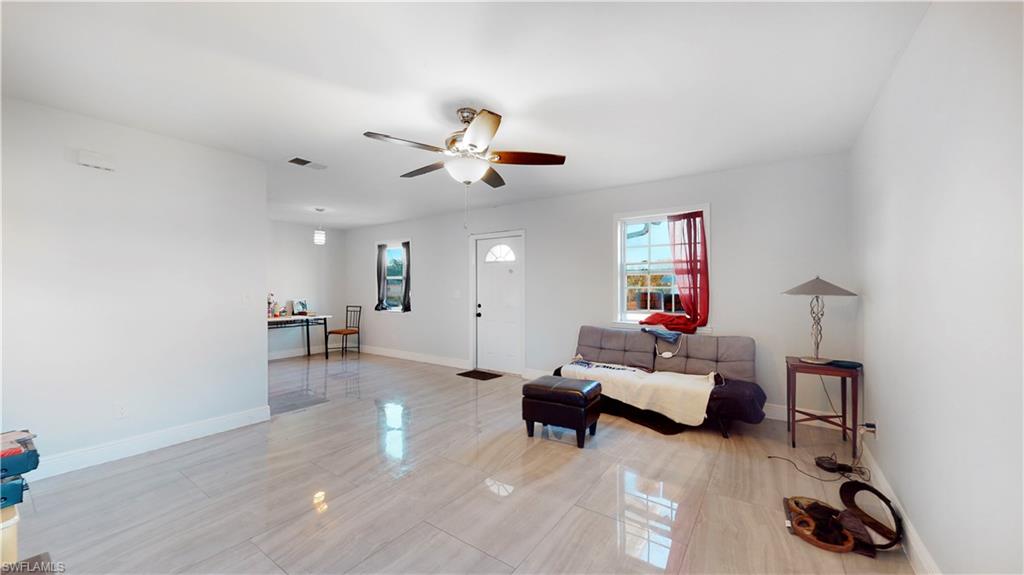 3903 35th Street Southwest Lehigh Acres, FL 33976 - Photo 3 of 16 a living room with furniture and a ceiling fan