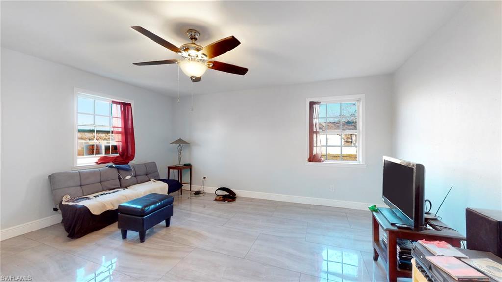 3903 35th Street Southwest Lehigh Acres, FL 33976 - Photo 4 of 16 a living room with furniture and a window