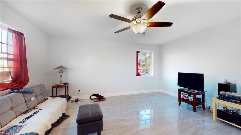 3903 35th Street Southwest Lehigh Acres, FL 33976 - Photo 5 of 16 a living room with furniture and a flat screen tv