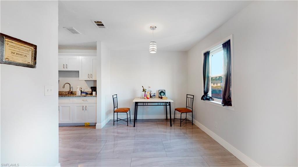 3903 35th Street Southwest Lehigh Acres, FL 33976 - Photo 6 of 16 a living room with furniture and a wooden floor