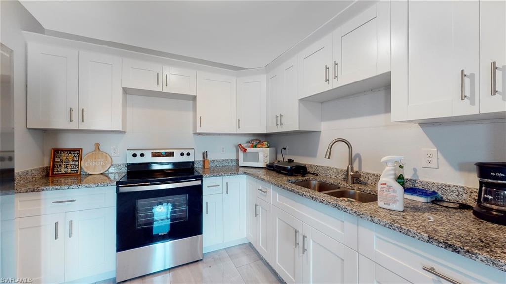 3903 35th Street Southwest Lehigh Acres, FL 33976 - Photo 8 of 16 a kitchen with granite countertop cabinets a sink and appliances