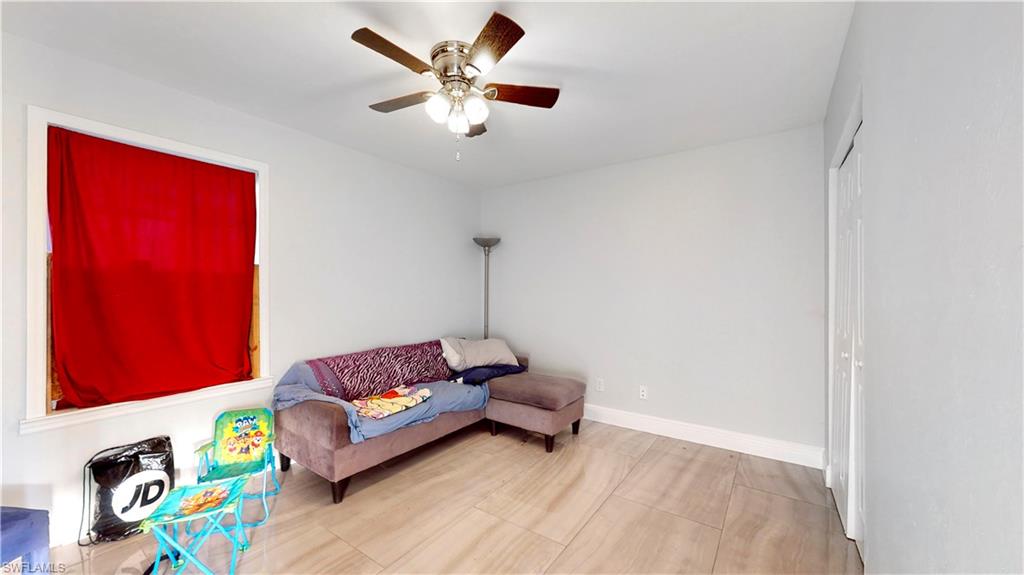 3903 35th Street Southwest Lehigh Acres, FL 33976 - Photo 9 of 16 a living room with furniture and a wooden floor