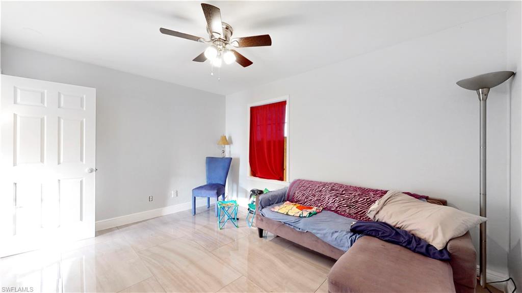 3903 35th Street Southwest Lehigh Acres, FL 33976 - Photo 10 of 16 a living room with furniture and a wooden floor
