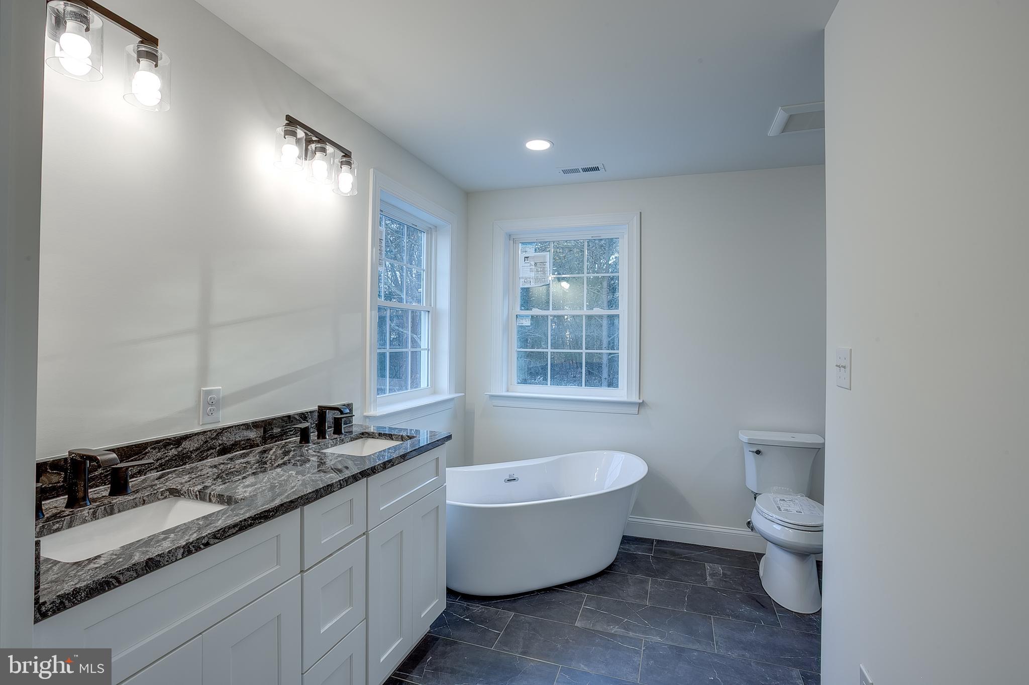 1427 Williamstown Erial Road Sicklerville, NJ 08081 - Photo 20 of 27 a bathroom with a granite countertop toilet a sink and a bathtub