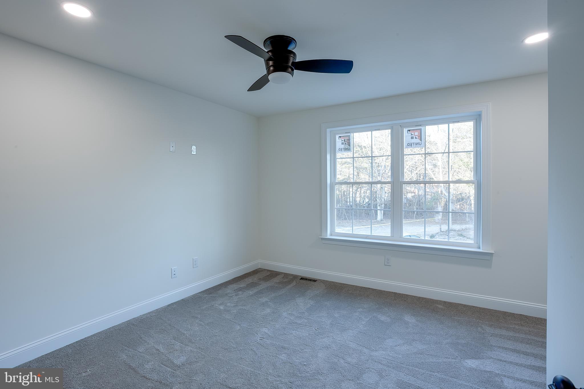 1427 Williamstown Erial Road Sicklerville, NJ 08081 - Photo 25 of 27 an empty room with a window and a ceiling fan
