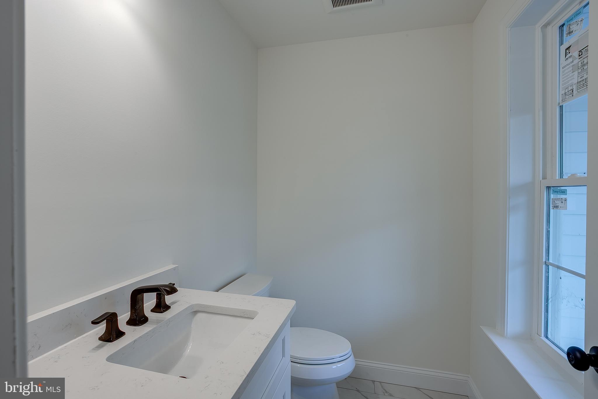 1427 Williamstown Erial Road Sicklerville, NJ 08081 - Photo 26 of 27 a bathroom with a sink a toilet and vanity