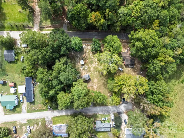 an aerial view of residential house with outdoor space and trees around