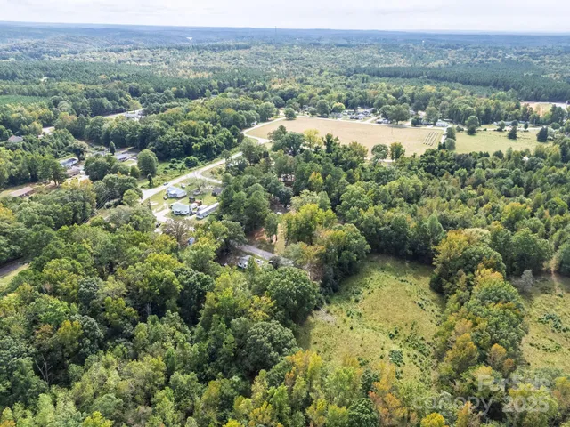 an aerial view of residential houses with outdoor space and river