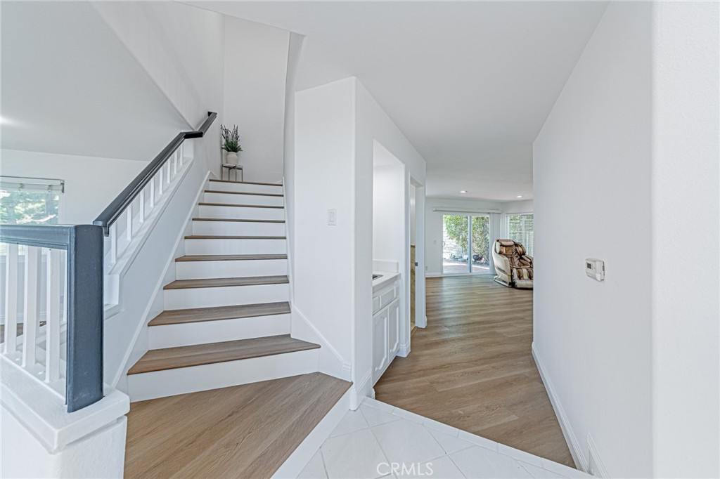 25533 Longfellow Place Stevenson Ranch, CA 91381 - Photo 17 of 47 a view of a hallway view with wooden floor and staircase