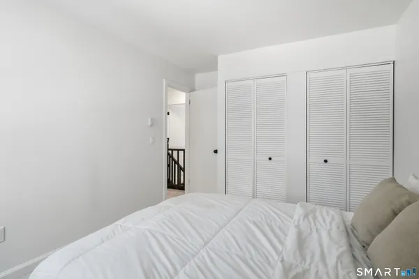 a bedroom with a bed and a closet