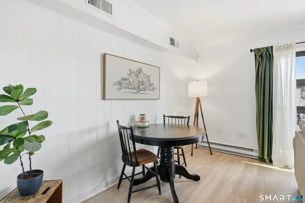 a view of a dining room with furniture and wooden floor
