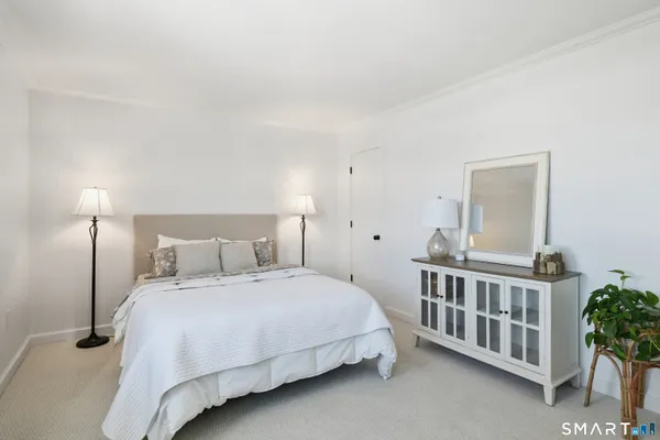 a bedroom with a bed and a table
