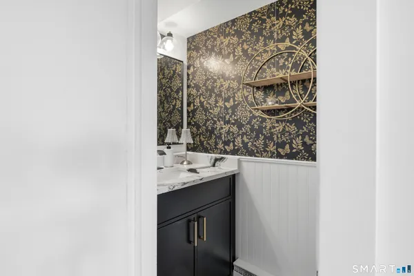 a bathroom with a granite countertop sink and shower